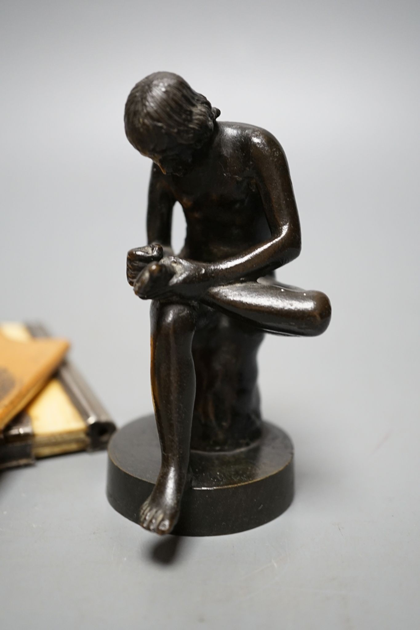 A bronze model, Spinario, 10cm., an ivory aide memoire and card case, wooden cases, etc.